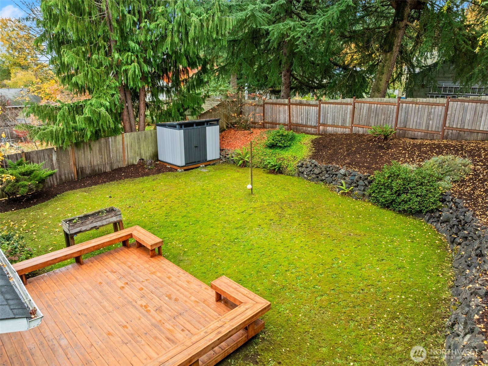 615 Clark Street Southwest Tumwater, WA 98512 - Photo 4 of 27 a view of a backyard with plants and wooden fence