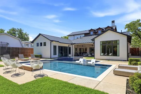 a view of a house with swimming pool and sitting area