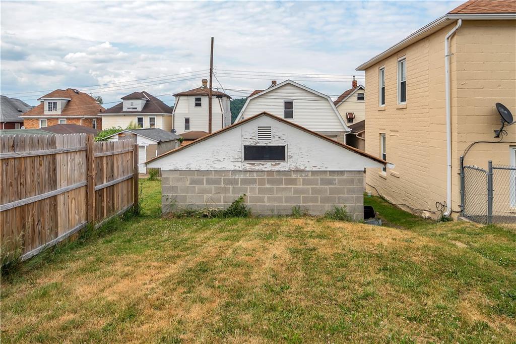 304 Beech Street Vandergrift, PA 15690 - Photo 2 of 25 a view of a big house with a small yard and wooden fence