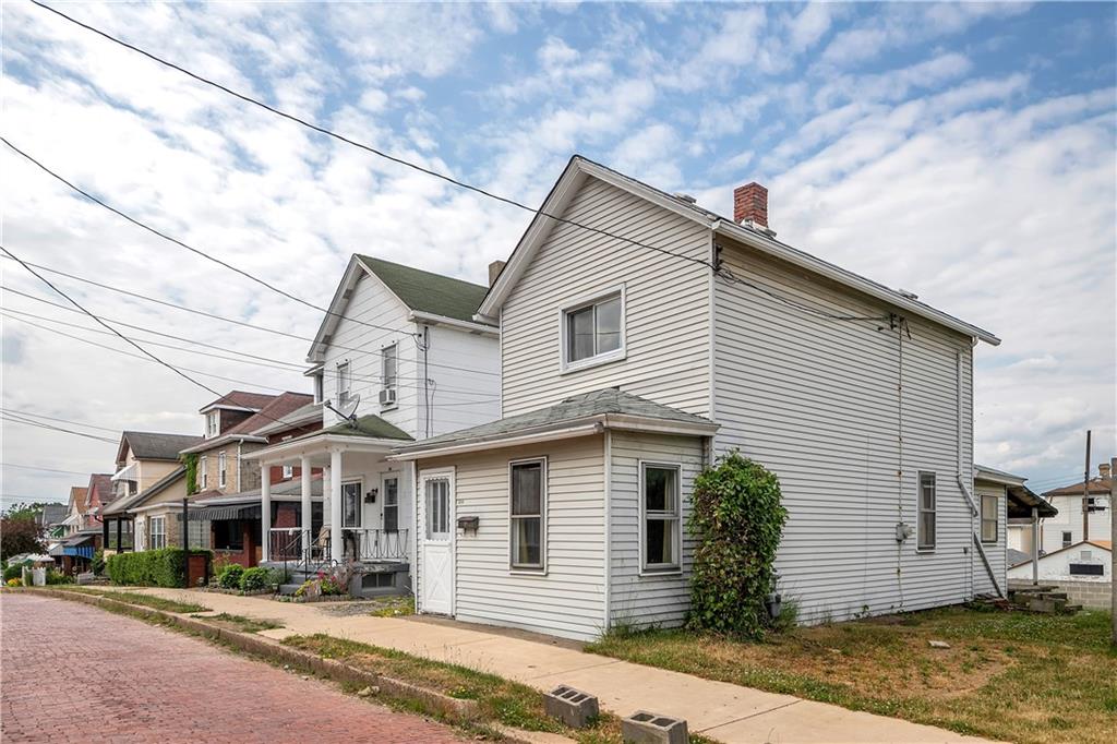 304 Beech Street Vandergrift, PA 15690 - Photo 22 of 25 a front view of a house with a yard