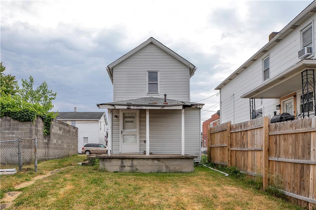 304 Beech Street Vandergrift, PA 15690 - Photo 24 of 25 a view of a house with a small yard and wooden fence