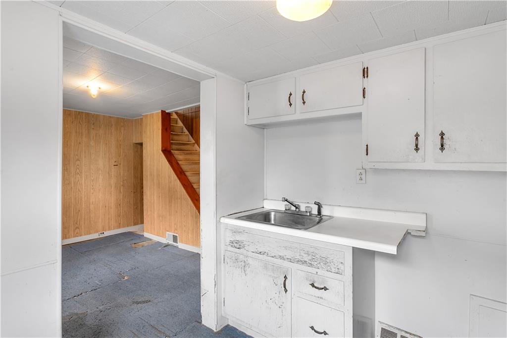 304 Beech Street Vandergrift, PA 15690 - Photo 4 of 25 a kitchen with sink cabinets and window
