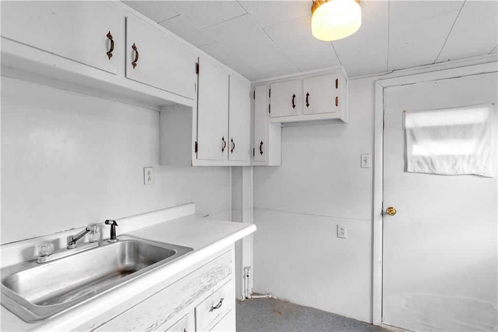 304 Beech Street Vandergrift, PA 15690 - Photo 5 of 25 a kitchen with stainless steel appliances granite countertop a sink and a white cabinets