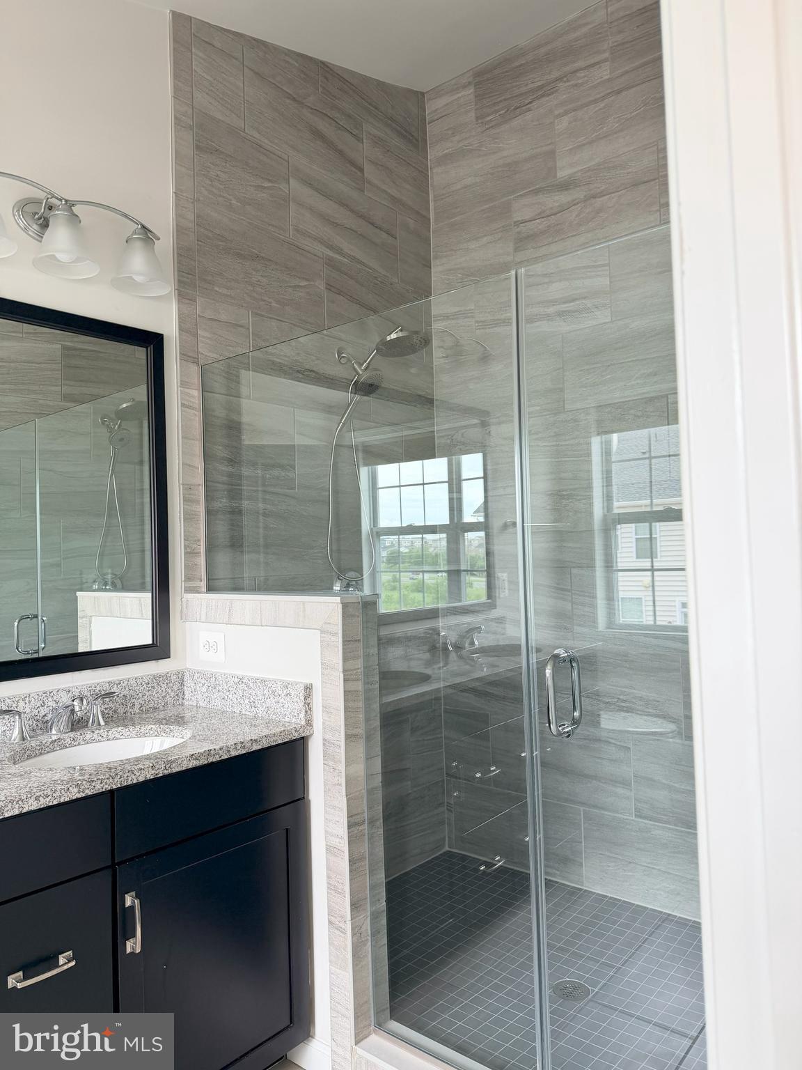 23463 Simms Gap Way Ashburn, VA 20148 - Photo 8 of 10 a bathroom with a shower sink and mirror