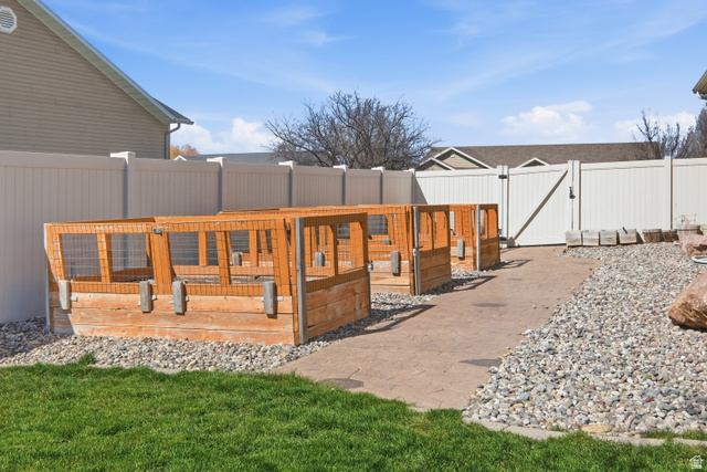 860 West 2980th Street South Logan, UT 84321 - Photo 37 of 38 Outdoor area featuring multiple wooden raised garden beds with mesh tops