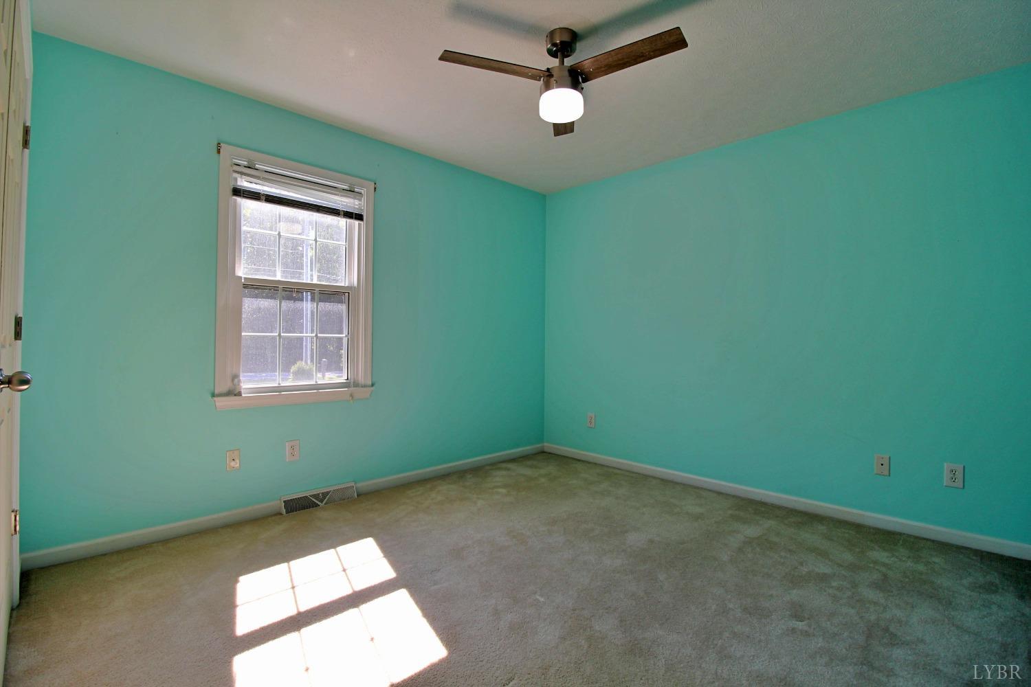 2899 Thomas Jefferson Road Forest, VA 24551 - Photo 11 of 22 an empty room with a window and a fan