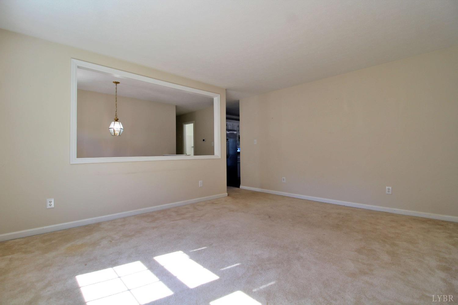 2899 Thomas Jefferson Road Forest, VA 24551 - Photo 5 of 22 a view of an empty room with wooden floor and a mirror