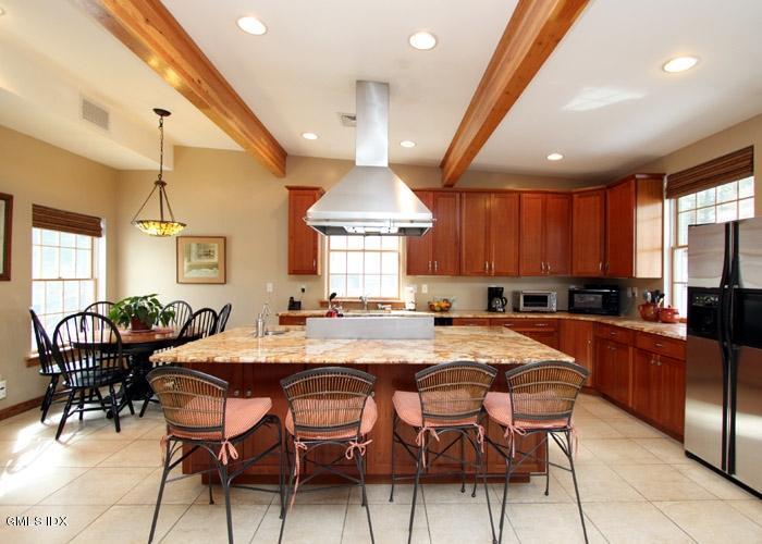446 Valley Road Cos Cob, CT 06807 - Photo 3 of 9 a large kitchen with a table and chairs