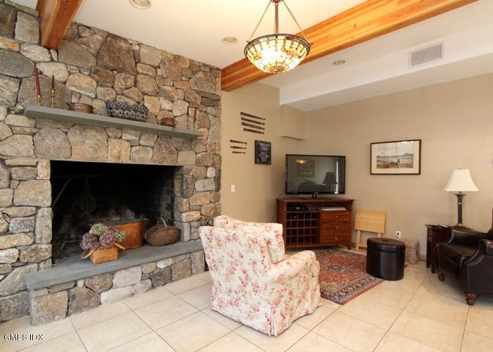 446 Valley Road Cos Cob, CT 06807 - Photo 4 of 9 a living room with furniture a flat screen tv and a fireplace