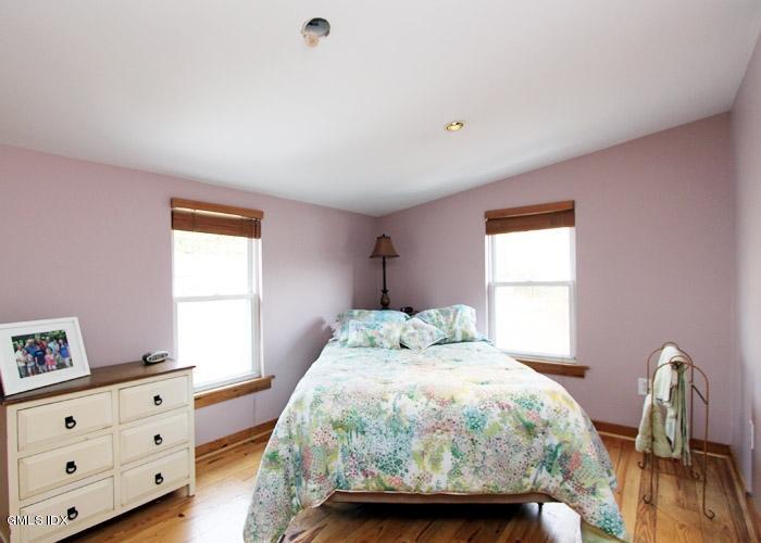446 Valley Road Cos Cob, CT 06807 - Photo 6 of 9 a bedroom with a bed next to a window with dresser