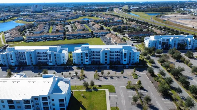 an aerial view of a residential houses with outdoor space and street view