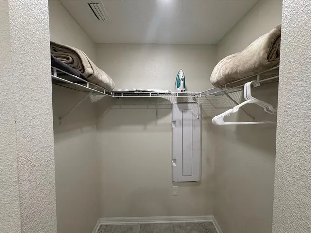 a bedroom with furniture and a chair