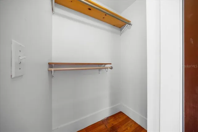 a view of room with wooden floor