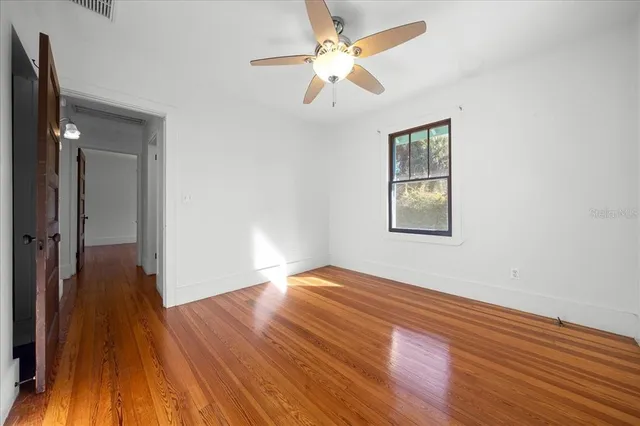 wooden floor in an empty room with a window