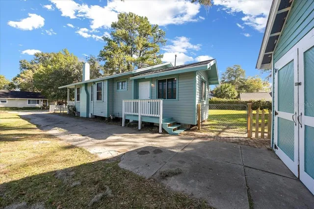 a view of a house with backyard and sitting area