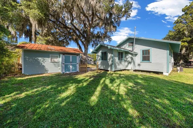 a front view of house with yard and green space