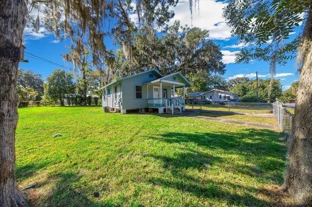 a front view of a house with yard and green space