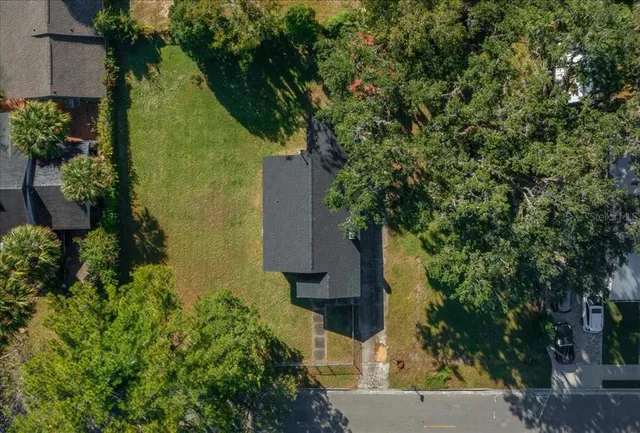 an aerial view of a house with a yard