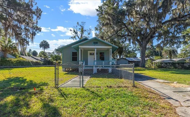a view of a house with swimming pool and a yard