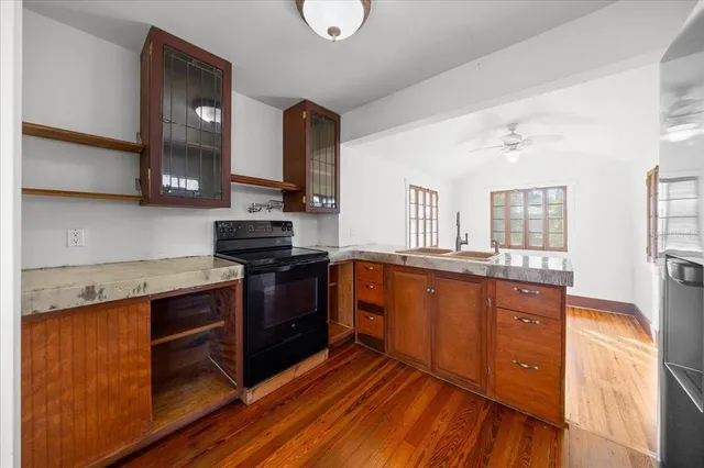 a kitchen with stainless steel appliances granite countertop a stove and cabinets