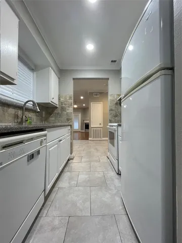 a bathroom with a granite countertop bathtub and sink