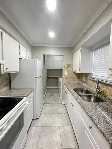 a kitchen with a sink microwave and cabinets
