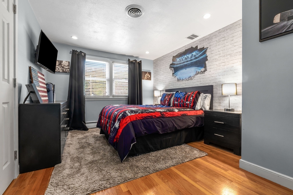 6 Susan Drive Saugus, MA 01906 - Photo 20 of 34 a spacious bedroom with a bed and a flat screen tv