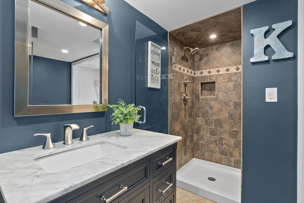 6 Susan Drive Saugus, MA 01906 - Photo 21 of 34 a bathroom with a granite countertop sink a mirror and shower