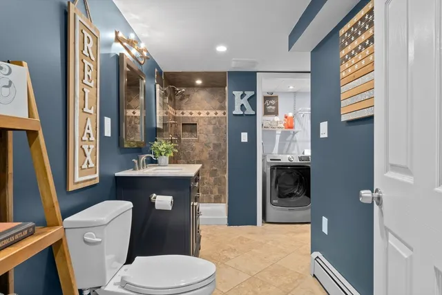 a bathroom with a toilet a sink and a mirror