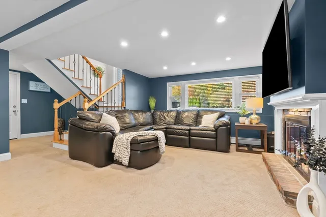 a living room with furniture fireplace and flat screen tv