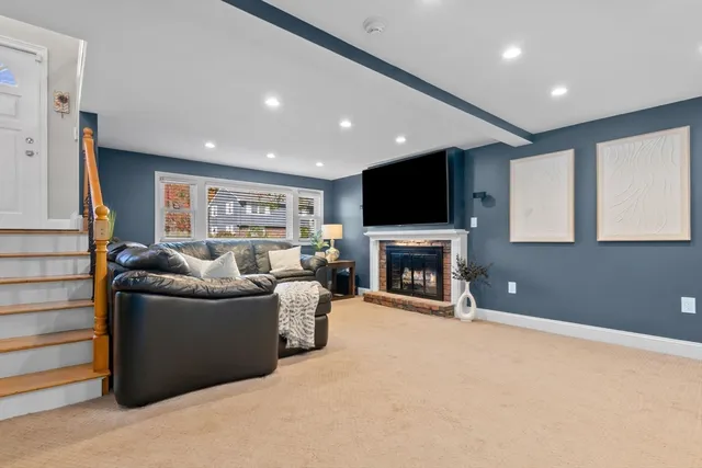 a living room with furniture a fireplace and a flat screen tv