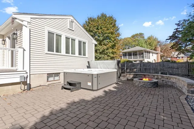 a backyard of a house with barbeque oven table and chairs