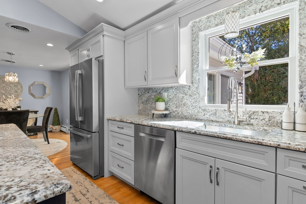 6 Susan Drive Saugus, MA 01906 - Photo 7 of 34 a kitchen with stainless steel appliances granite countertop a sink and a refrigerator