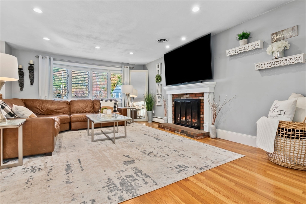 6 Susan Drive Saugus, MA 01906 - Photo 10 of 34 a living room with furniture a flat screen tv and a fireplace