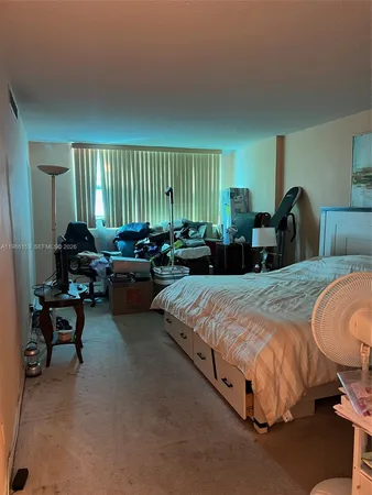 a spacious bedroom with two beds and a couch