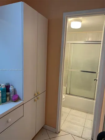 a bathroom with a shower and a sink