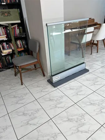 a view of a livingroom with workspace and a window