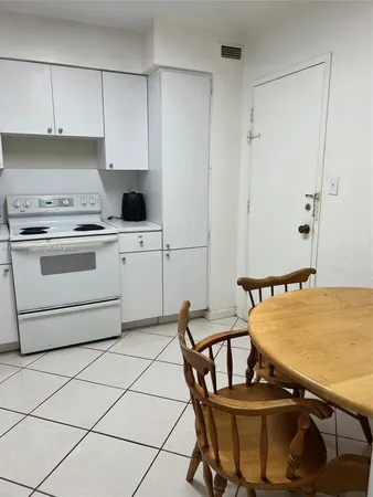 a kitchen with a stove and a table