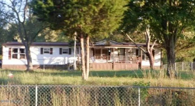 a front view of a house with a yard table and chairs