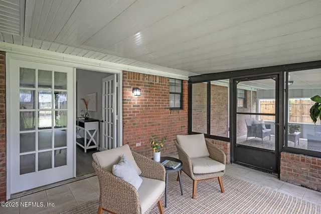 a living room with furniture a fireplace and a large window