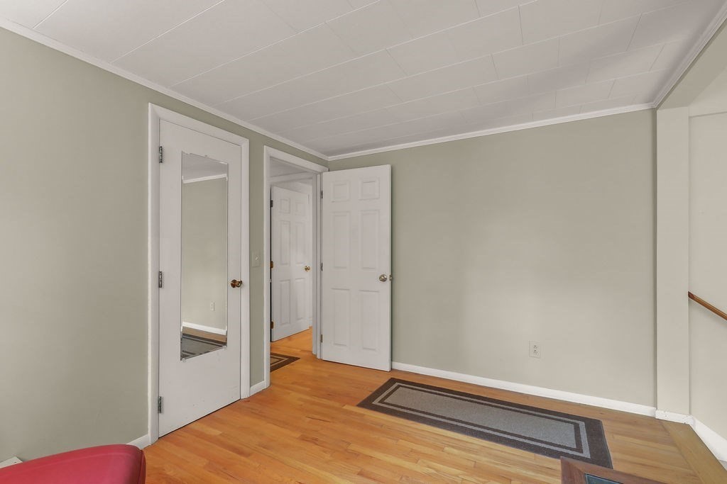 94 Fearing Hill Road Wareham, MA 02576 - Photo 12 of 41 a bedroom with a bed and wooden floor