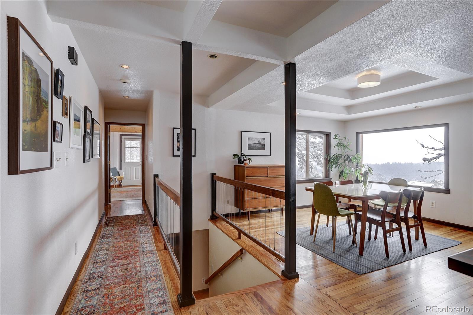 1094 Colorow Road Golden, CO 80401 - Photo 13 of 40 a view of a dining room with furniture window and wooden floor