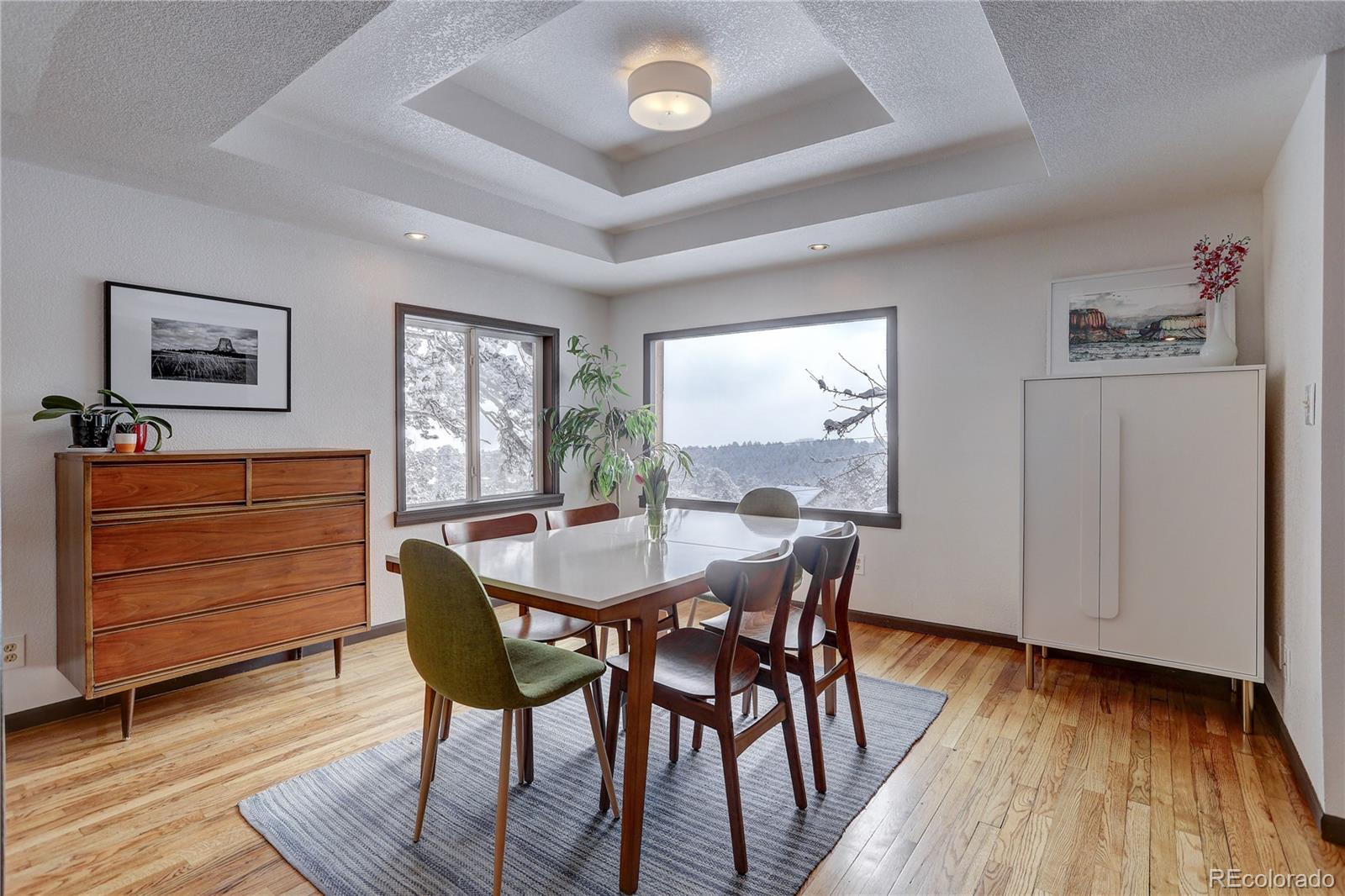 1094 Colorow Road Golden, CO 80401 - Photo 14 of 40 a dining room with furniture and wooden floor