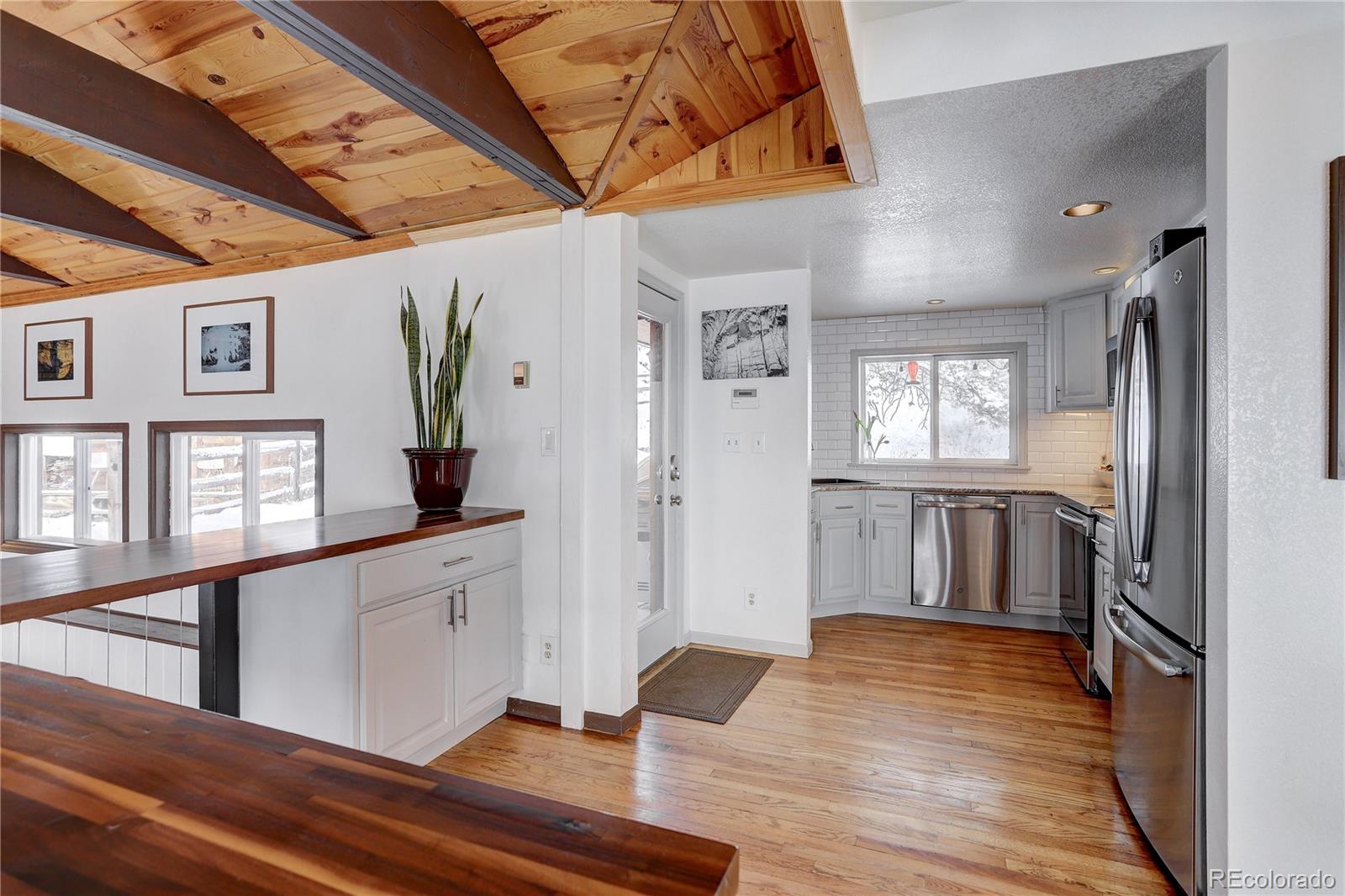 1094 Colorow Road Golden, CO 80401 - Photo 17 of 40 a view of a hallway with wooden floor and staircase