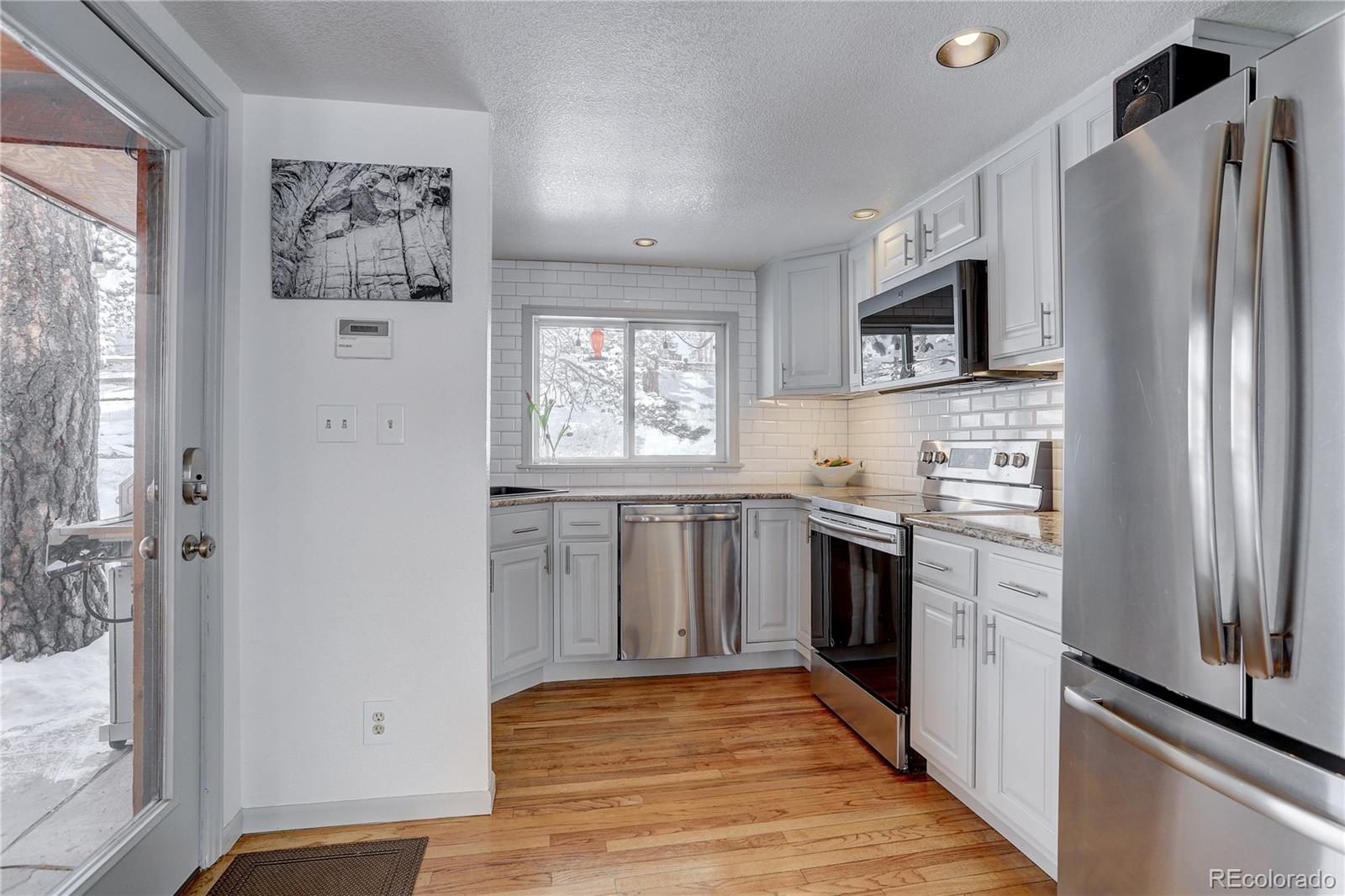 1094 Colorow Road Golden, CO 80401 - Photo 18 of 40 a kitchen with stainless steel appliances a refrigerator sink and stove