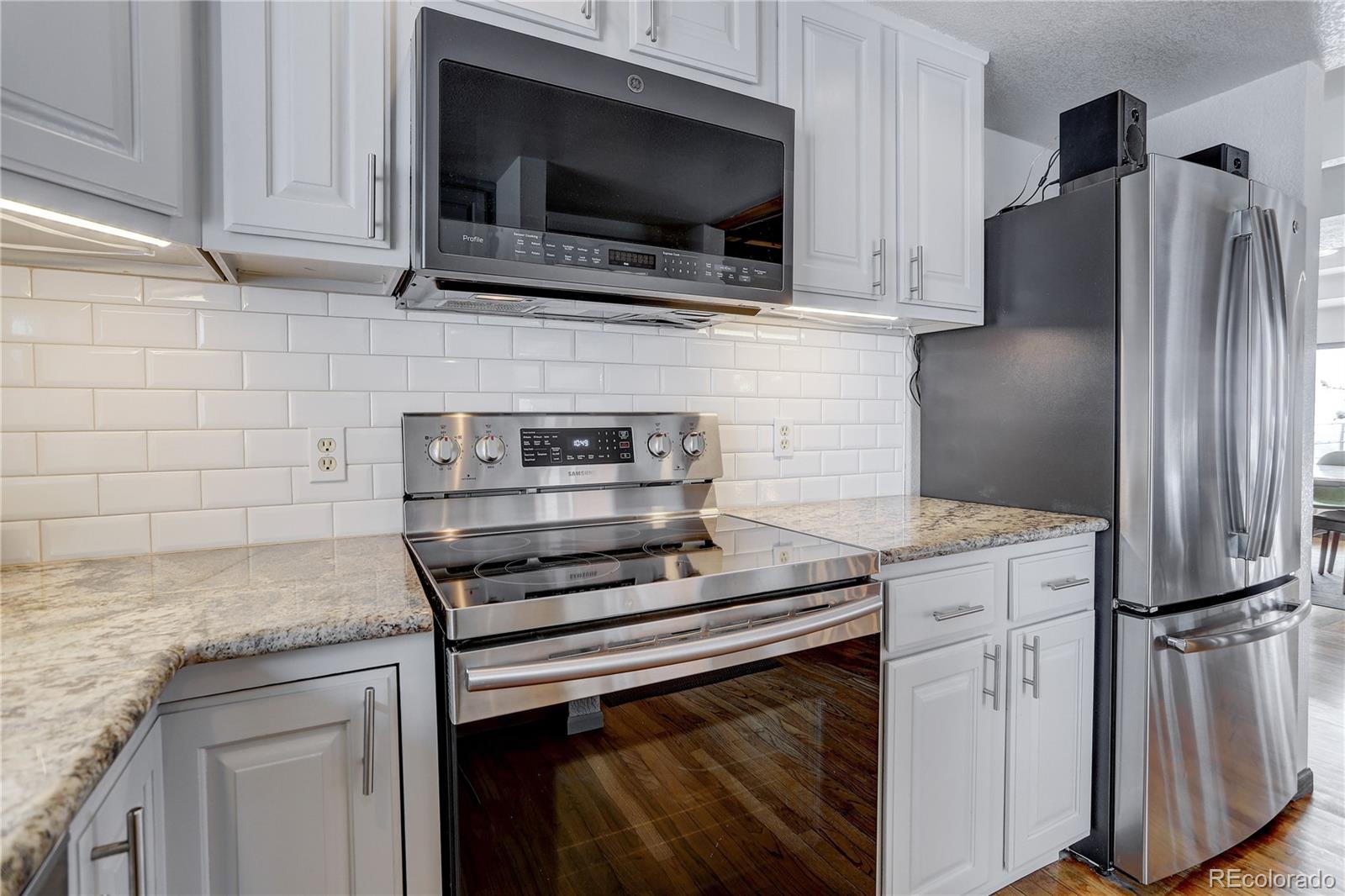1094 Colorow Road Golden, CO 80401 - Photo 20 of 40 a kitchen with stainless steel appliances granite countertop a stove microwave and refrigerator