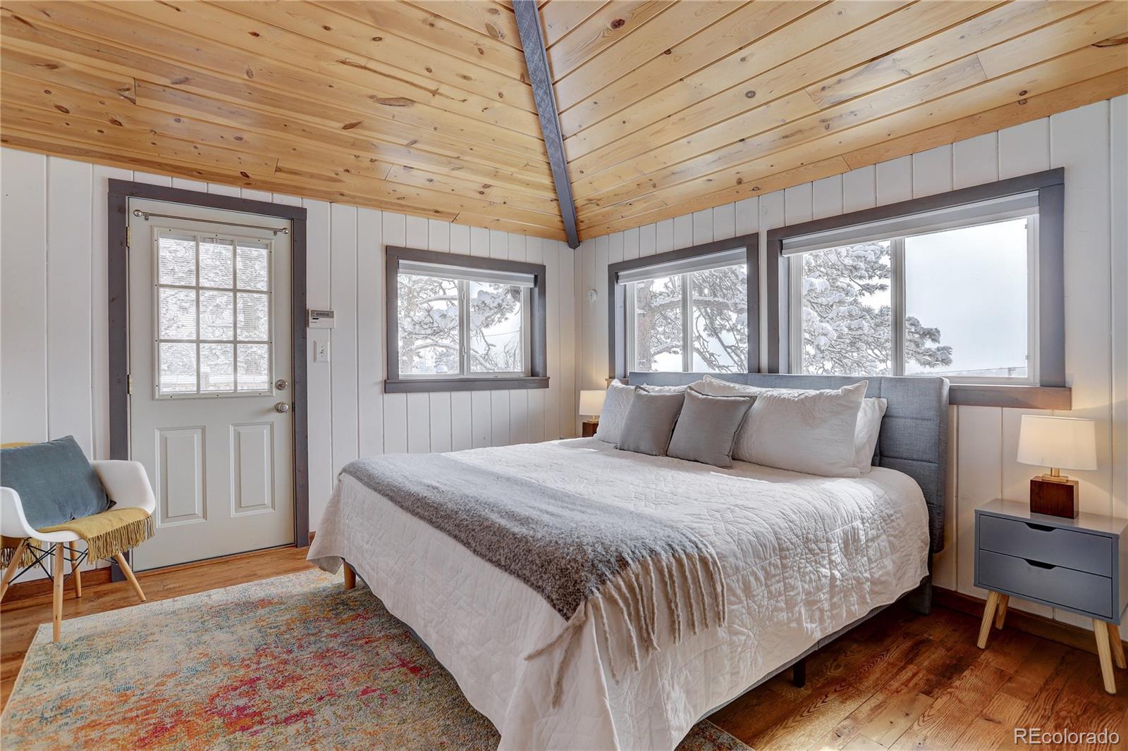 1094 Colorow Road Golden, CO 80401 - Photo 21 of 40 a bedroom with a large bed and a chair