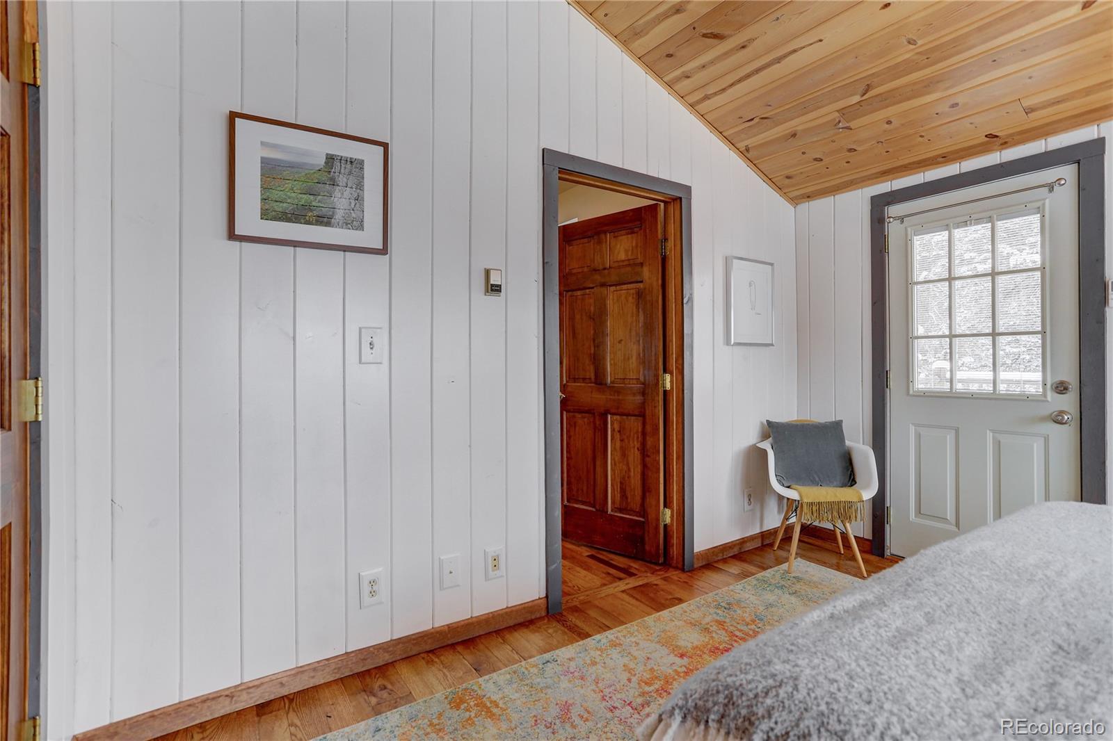 1094 Colorow Road Golden, CO 80401 - Photo 26 of 40 a bedroom with a bed and a chair