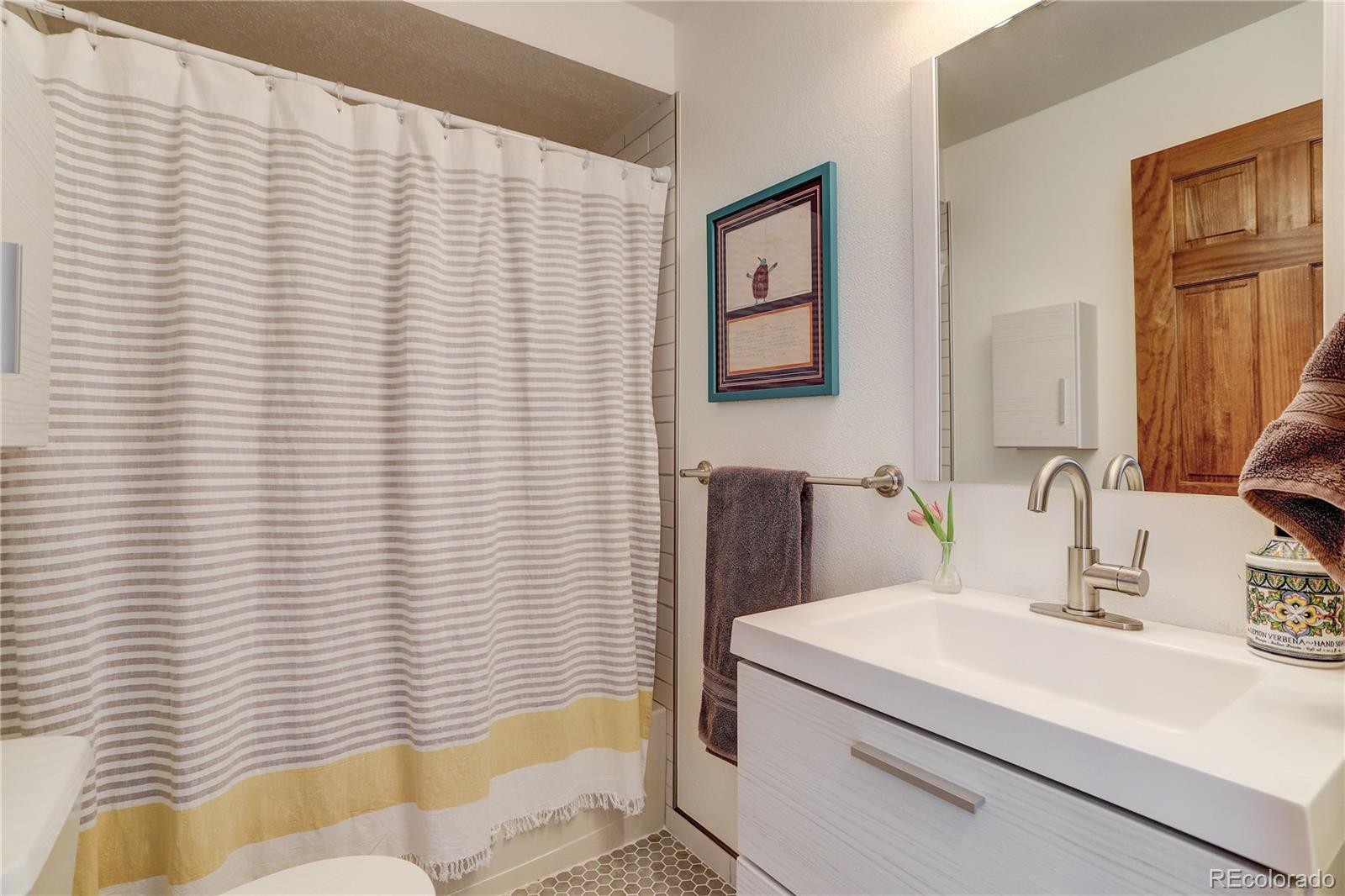 1094 Colorow Road Golden, CO 80401 - Photo 29 of 40 a bathroom with a sink a mirror and a shower
