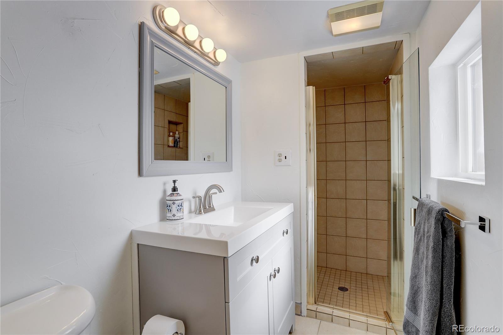 1094 Colorow Road Golden, CO 80401 - Photo 34 of 40 a bathroom with a sink a toilet and shower